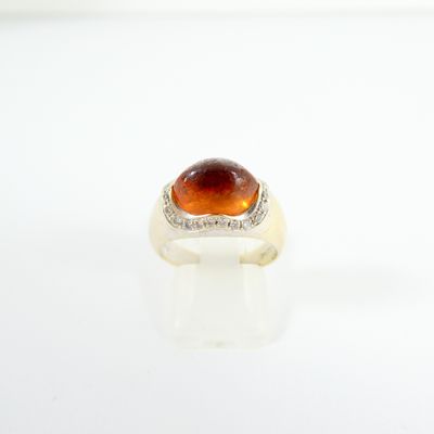 an image of a ring with a large orange stone on it