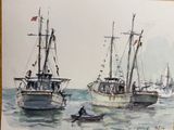two boats in the water with a man in a boat