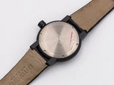 a close up of a watch on a white surface with a white background