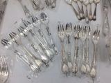 a lot of forks and spoons that are wrapped in plastic