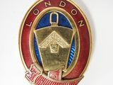 an image of a gold and red badge with a birdhouse on it