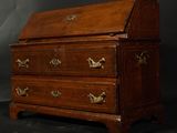 a small wooden chest of drawers on a black background