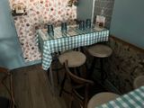 a table with four stools and a blue and white checkered table cloth
