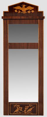 a mirror with a bird design on it and a mirror with a bird design on it