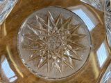 a clear glass bowl with a star design on it