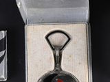a bottle opener with a picture of a woman in a red dress on it