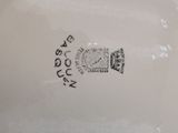a close up of a plate with a clock on it