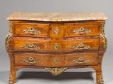 a marble top chest of drawers on display in a room