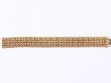 a close up of a gold chain bracelet on a white background