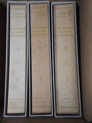 three books in a box are sitting on top of each other