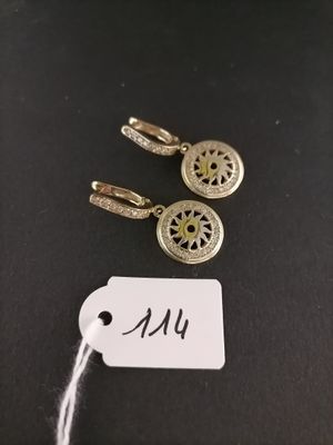 a close up of a tag with a pair of earrings on it