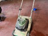 a lawn mower that is sitting on the floor