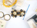 a table with a bunch of items that include rings, bracelets, and other items