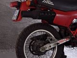 a red motorcycle that is parked in a garage