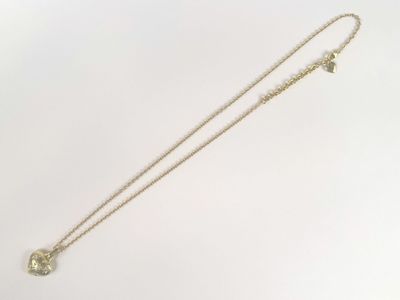 a close up of a necklace on a white surface