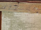 a close up of a piece of wood with writing on it