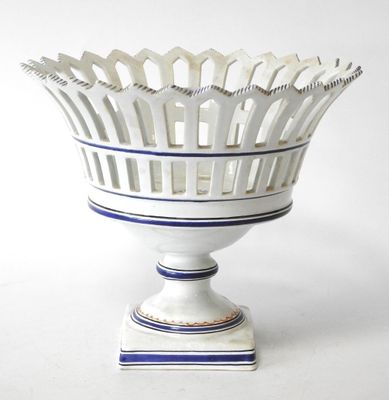 a white vase with a blue stripe around it