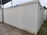 an image of a white storage container sitting in the dirt