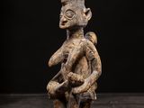 a wooden statue of a man with a hat on his head