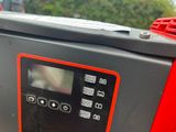 an image of a red and black machine with buttons