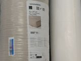 a roll of paper sitting on a shelf next to a roll of paper