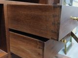 a wooden cabinet with two drawers in it