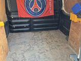 the inside of a van with a red and blue flag in the back