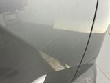 a close up of a car ' s door handle with a reflection of a building in the background