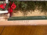 a toy train set up on a table next to a christmas tree