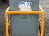 a yellow cart with a gray container on it
