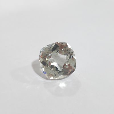 a close up of a white diamond on a white surface