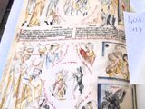 an open book with drawings on it sitting on a table