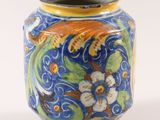 a blue vase with a design of flowers and birds on it