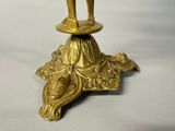 a gold statue of a man standing on top of a table