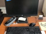 a desk with a keyboard, mouse, and monitor on it