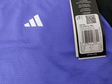 a close up of a blue shirt with a tag on it