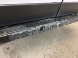 a close up of the bumper of a white truck