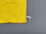 a yellow flag on a gray surface with a tag on it