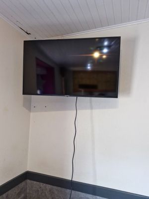 a flat screen tv mounted on the wall in the corner of a room