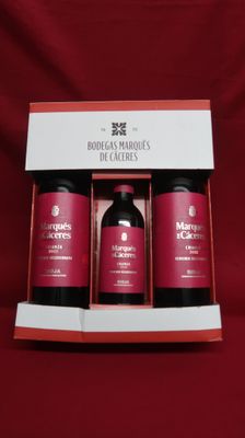 three bottles of body care products in a box on a red background