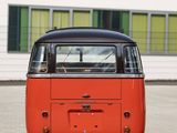 an orange vw bus parked in front of a white building