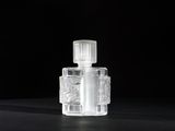 close up of a clear glass bottle on a black surface