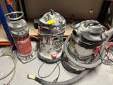several vacuums are sitting on a table in a room