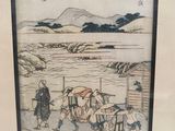 japanese woodblock painting of a man and woman with a cart of goods