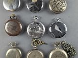 many different types of pocket watches on the table