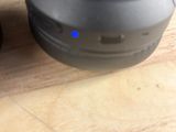 two speakers sitting on a wooden table next to each other
