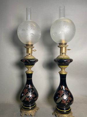 pair of black and gold vase lamps with birds on them