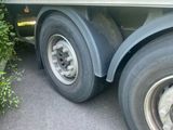 a truck with a flat tire parked on the side of the road