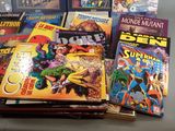 a lot of comic books sitting on a table