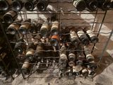 many bottles of wine in a metal rack on the floor